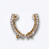 Gold and clear crystal hoop earring on a light gray background