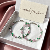 Jewelry set with two bracelets pink and green floral design in a box with 'made for two' card.