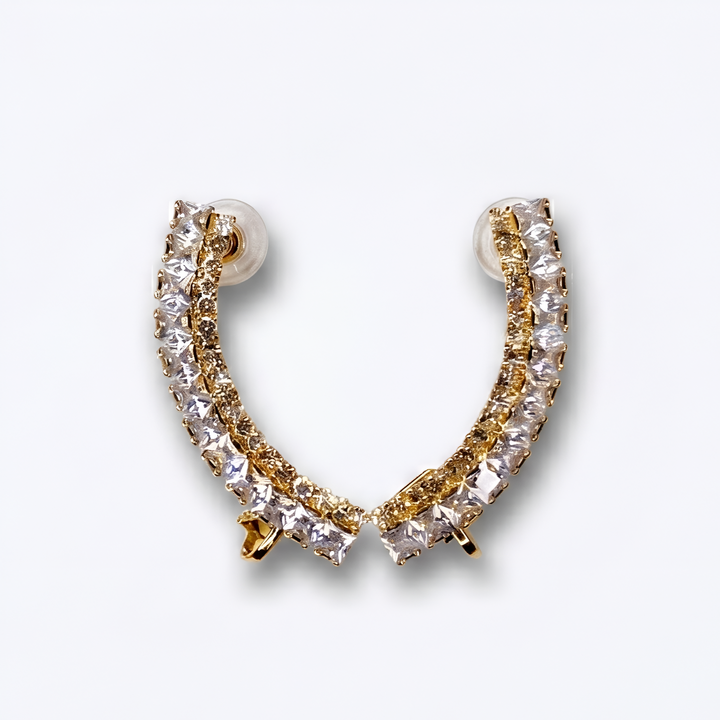 Gold and clear crystal hoop earring on a light gray background