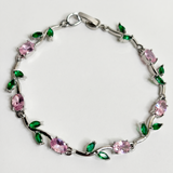 ORÈVE silver vine bracelet with pink oval crystals and green leaf gems