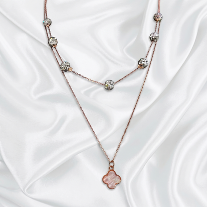 Necklace with floral pendant on a white satin background