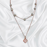 Necklace with floral pendant on a white satin background