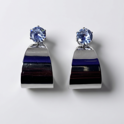 Pair of earrings with blue gemstones on a white background