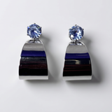 Pair of earrings with blue gemstones on a white background