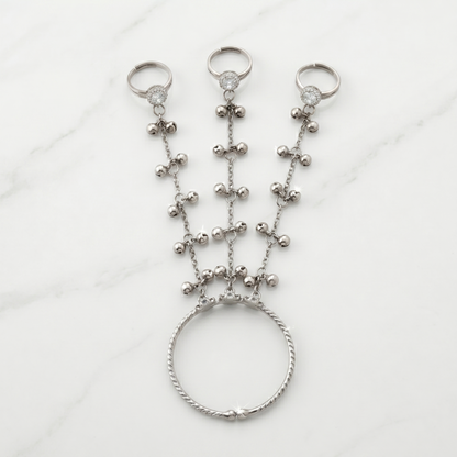 Silver beaded hand chain on a white background