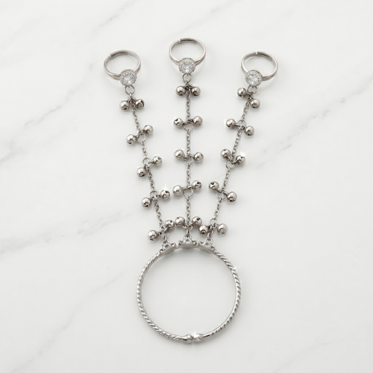 Silver beaded hand chain on a white background