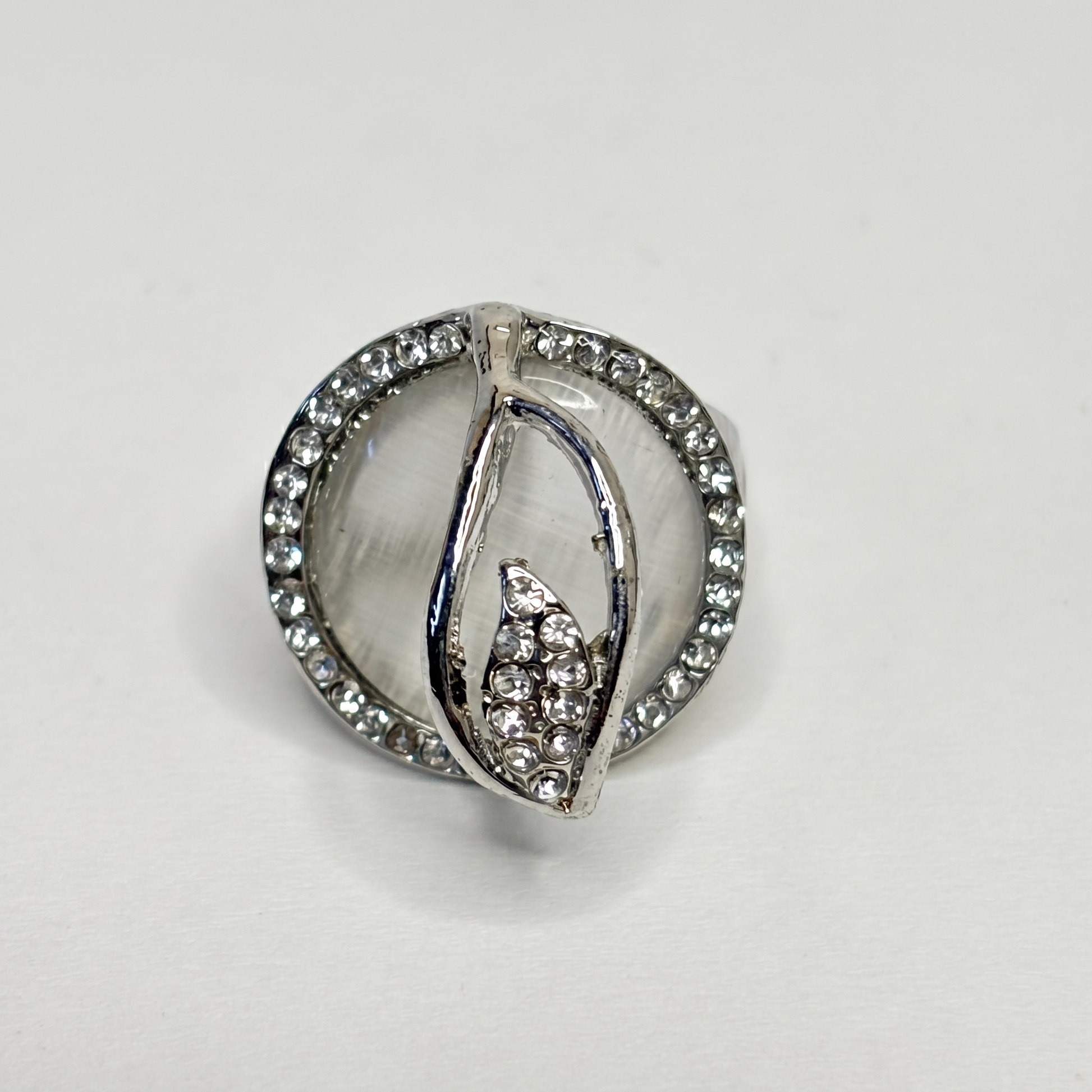 Silver ring with gemstones on a light gray background