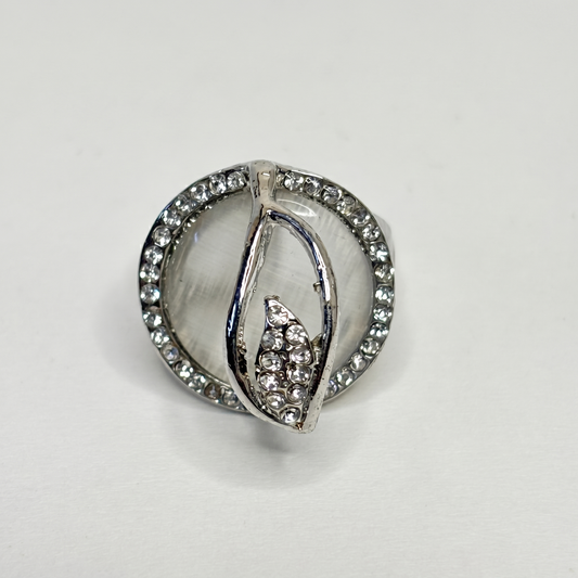 Silver ring with gemstones on a light gray background