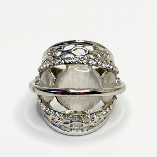 Silver ring with intricate design on a white background