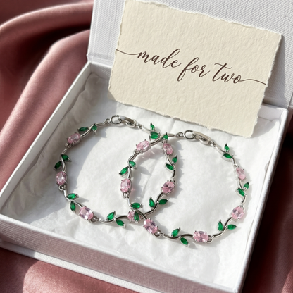Jewelry set with two bracelets pink and green floral design in a box with 'made for two' card.