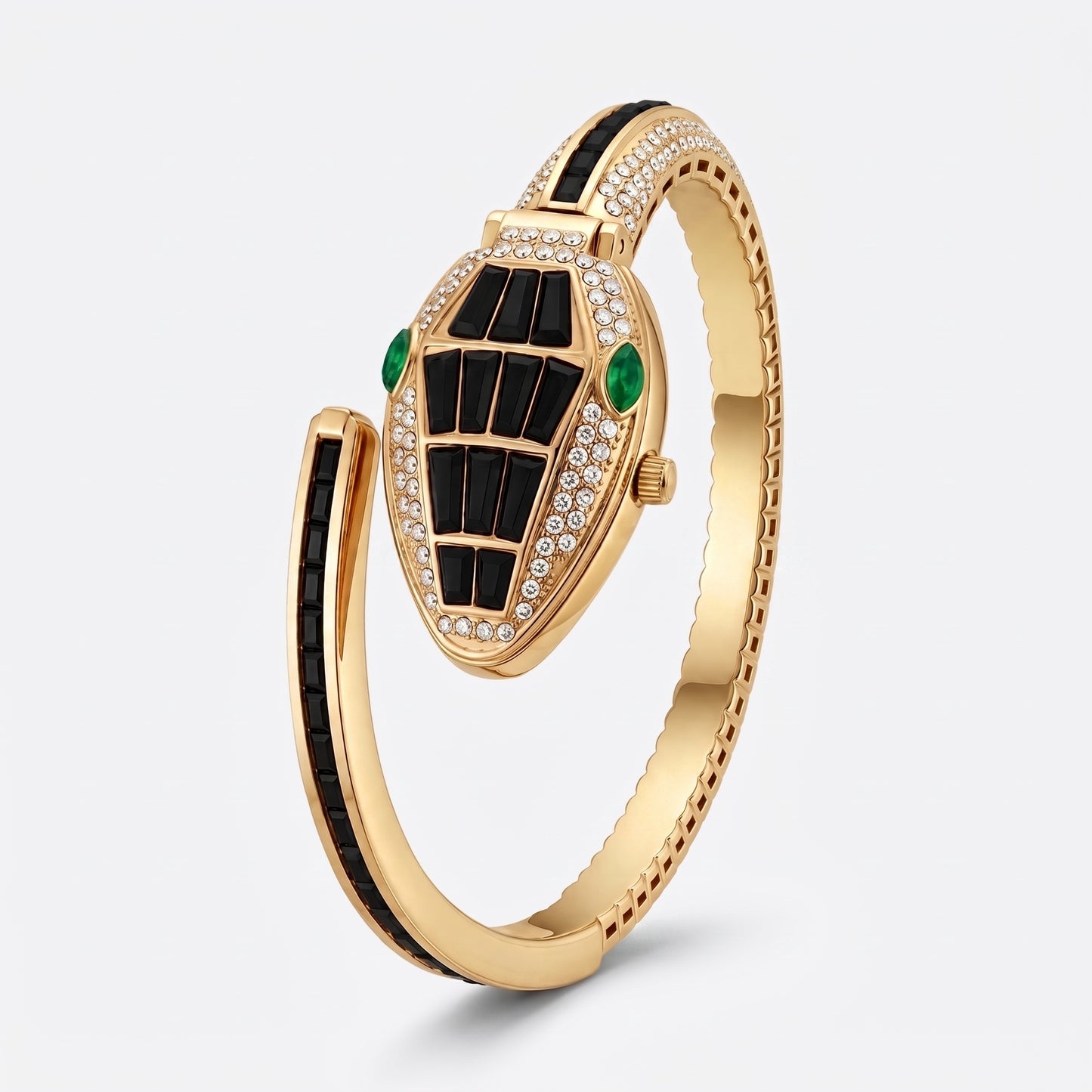 A gold-tone snake-head bangle bracelet featuring black enamel detailing, green stone accents, and pavé-set clear stones, shown on a light gray background.
